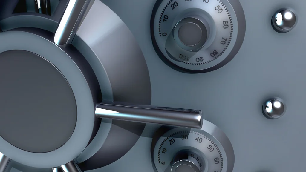 The door of a bank vault, its two combination dials in close view